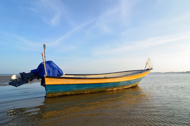 Boat near the beach when the sun goes down