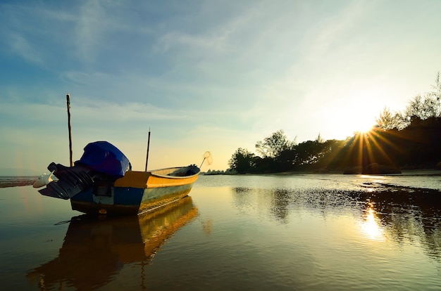 Boat near the beach when the sun goes down