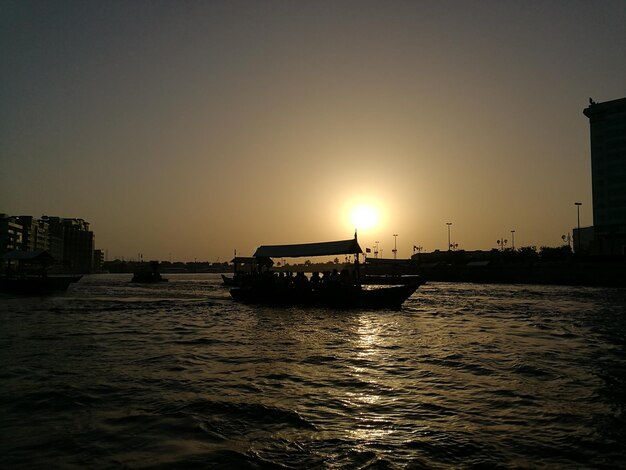 Boat in river against built structures