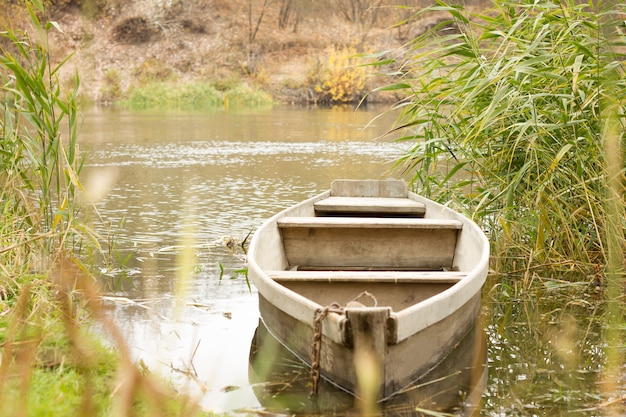 Boat on the river in autumn, boat in the village, countryside