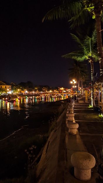 Photo a boat in the river at night with a romantic lunar festival in hoi a heritage center