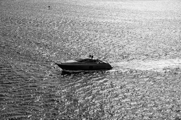 Boat sail on silver sea water waves in Miami USA