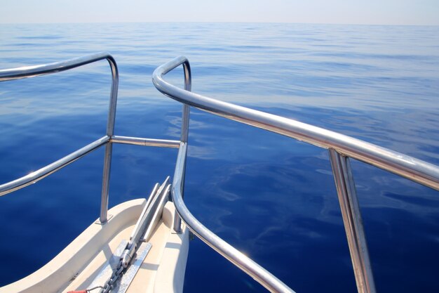 Boat sailing blue calm ocean sea bow railing