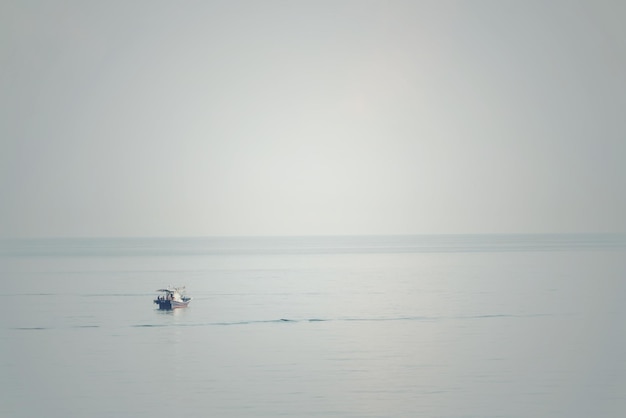 Boat sailing in sea against clear sky