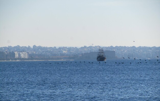 Boat sailing in sea against clear sky