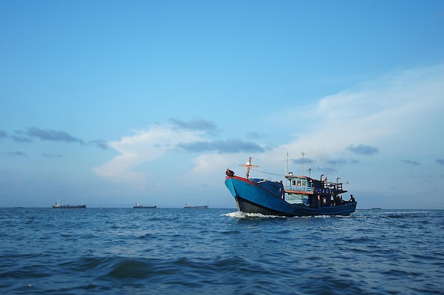 Boat sailing in sea against sky