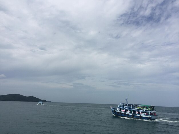 Boat sailing in sea against sky