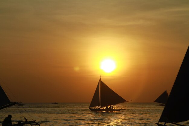 Boat sailing in sea during sunset