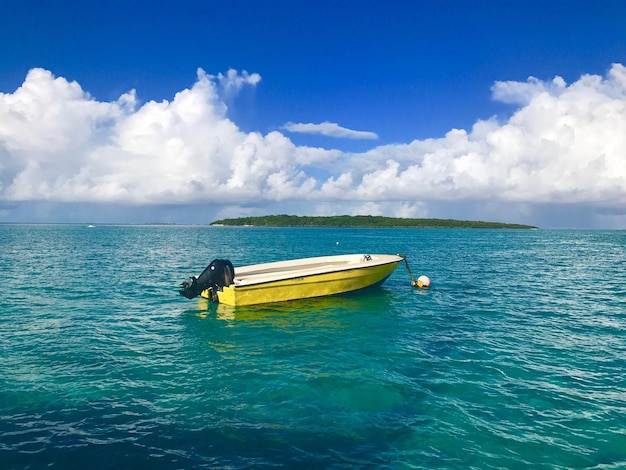 Boat in sea against blue sky