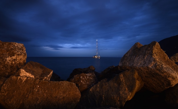 boat in the sea with a frame of rocks