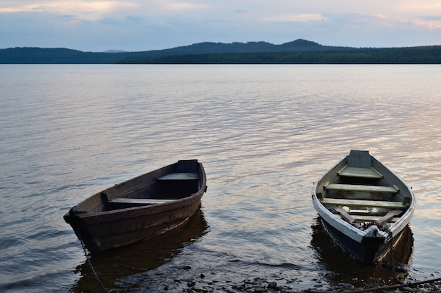 Boat on the shore of the lake. evening