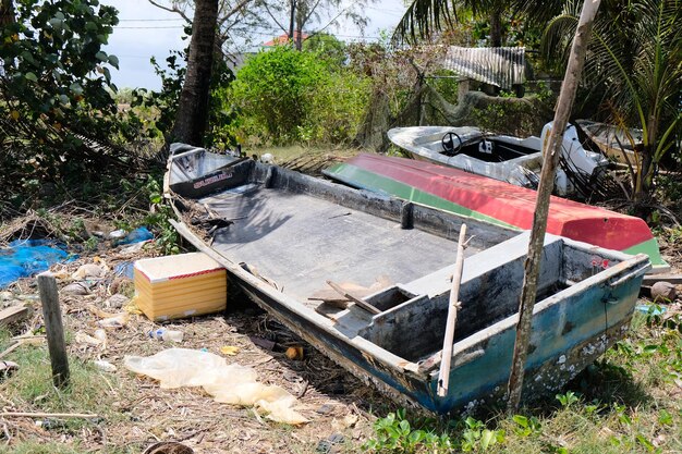 A boat that has been abandoned in a field.