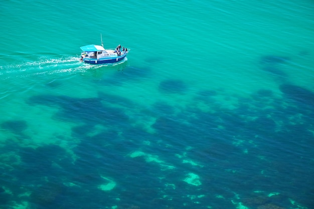 Boat on transparent sea surface