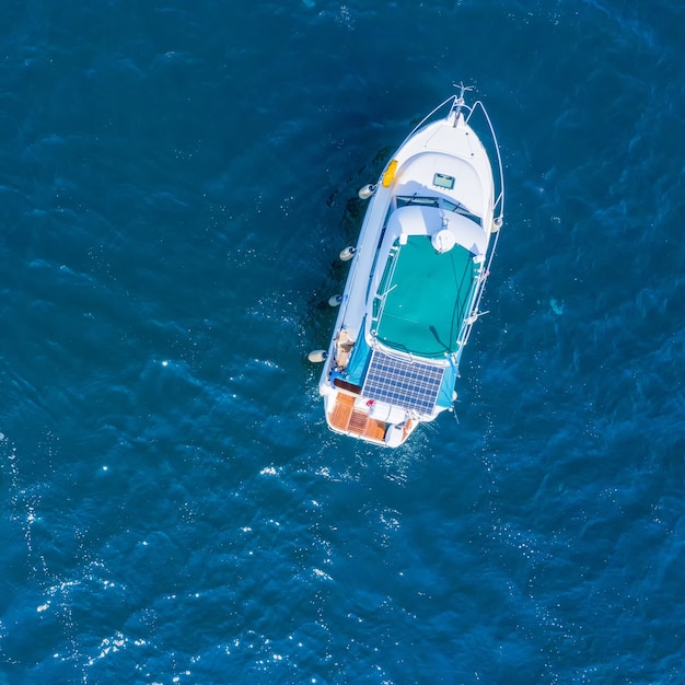 Boat on the water surface drone view.