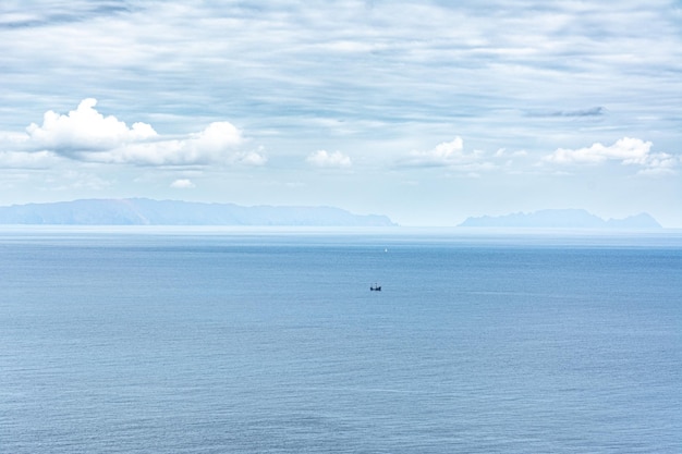 A boat in the water with mountains in the background