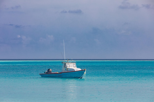 A boat in the water with the name of the boat on it