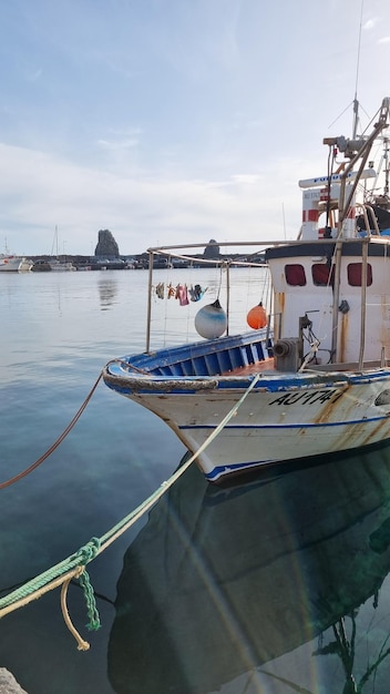 A boat in the water with the name la marina on the front.