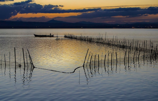 A boat in the water with a net in the foreground.