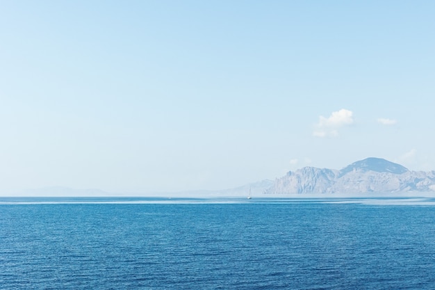 Boat with tourists on blue sea surface. Nature background