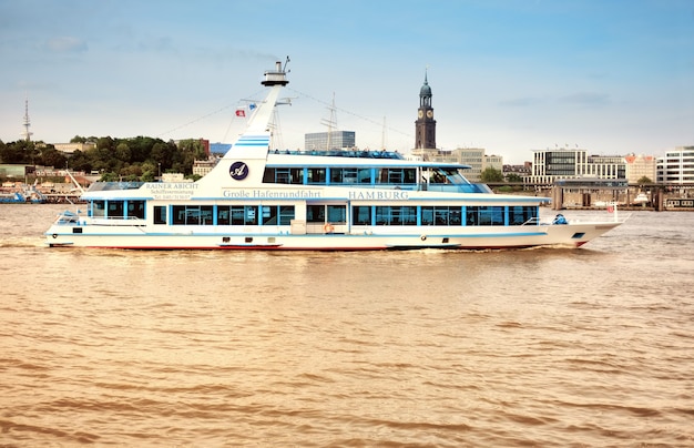 Boat with tourists goes on Elbe river in Hamburg