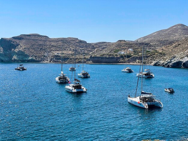 Boats on the aegean sea - red beach in santorini greece