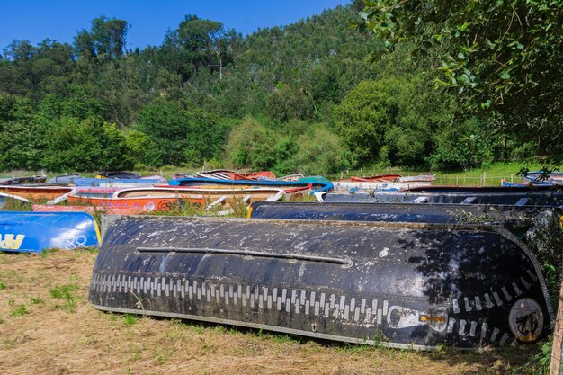 Photo boats are stored outdoors on the grass