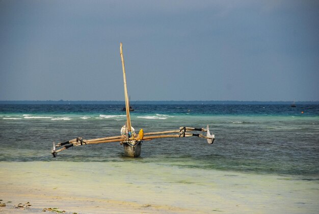 Boats beach blue sky Zanzibar