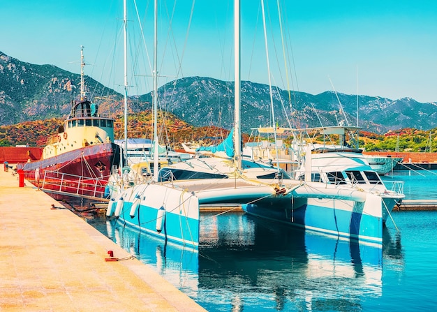 Boats in Beautiful Port of Villasimius in the Bay of the Blue Waters of the Mediterranean Sea on Sardinia Island in Italy in summer. Cagliari region.