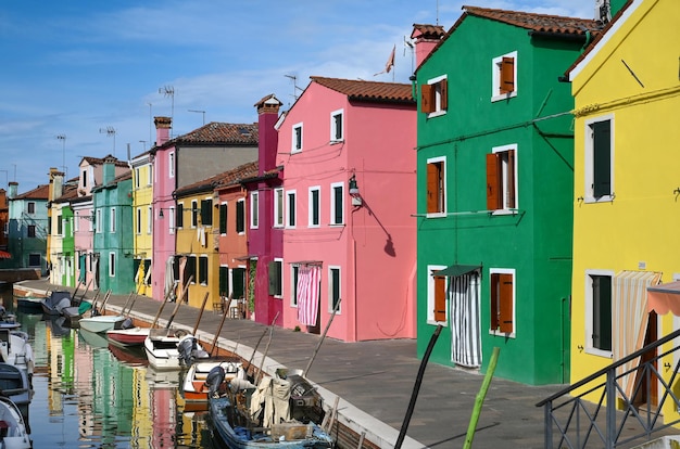 Boats in canal near colorful houses