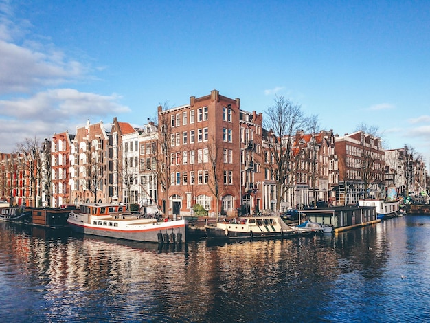 Boats in city against sky
