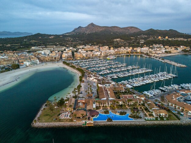 Boats and houses on water with mountains in the backdrop Mallorca