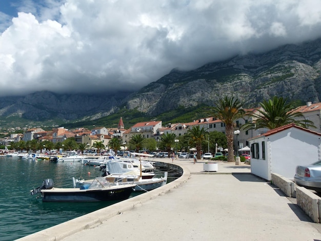 boats moored by pier in sea against sky