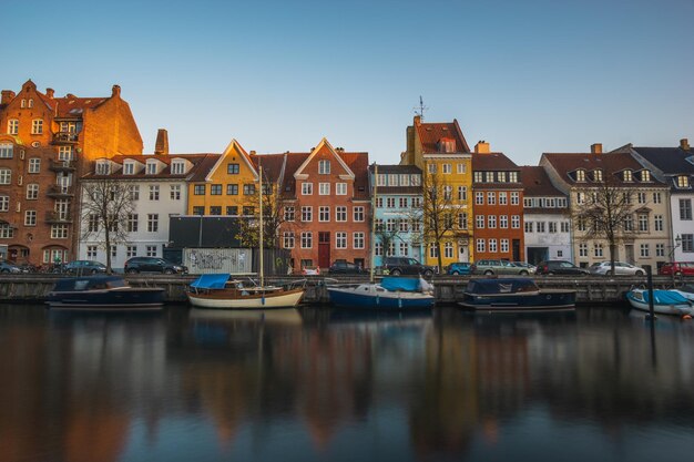 Photo boats moored in canal by buildings against sky