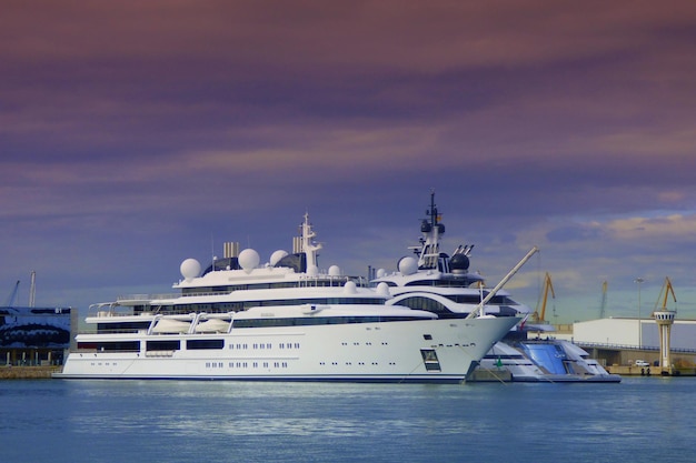 boats moored at harbor against sky during sunset