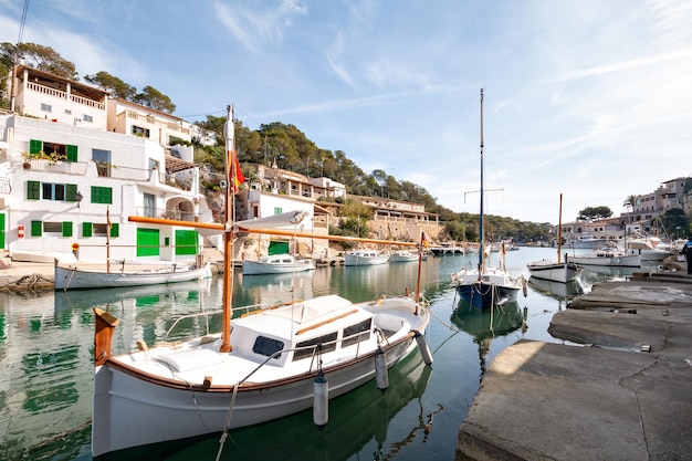 Boats moored at harbor against sky