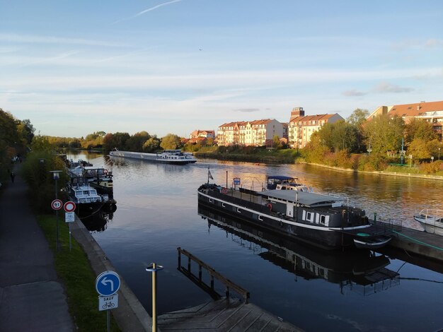 Boats moored in river against sky