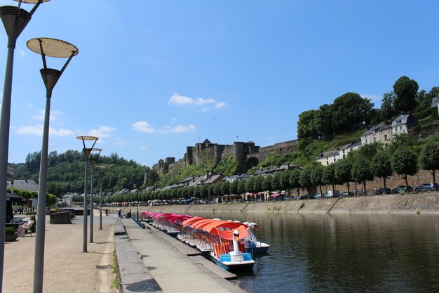 Boats moored in river against sky