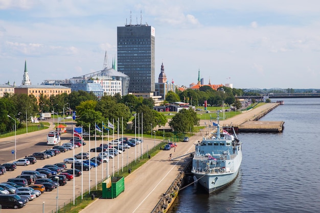 Boats in river amidst buildings in city against sky