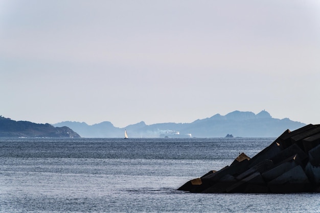 Boats sailing in the Ria de Pontevedra in Galicia at dusk with the Cies Islands in the background