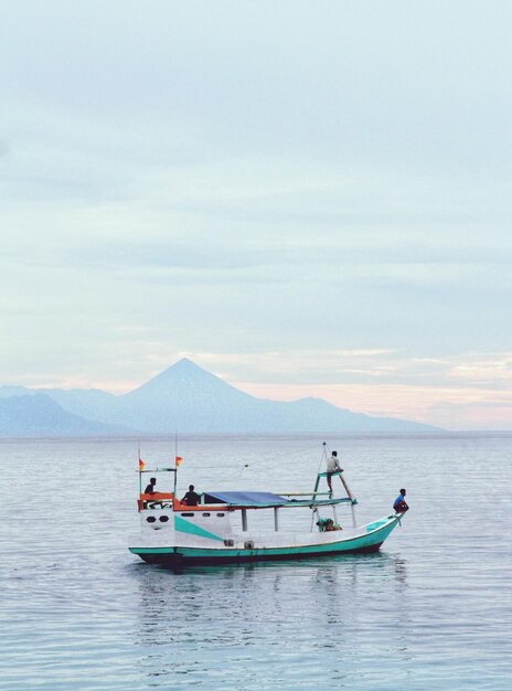 Boats in sea against sky