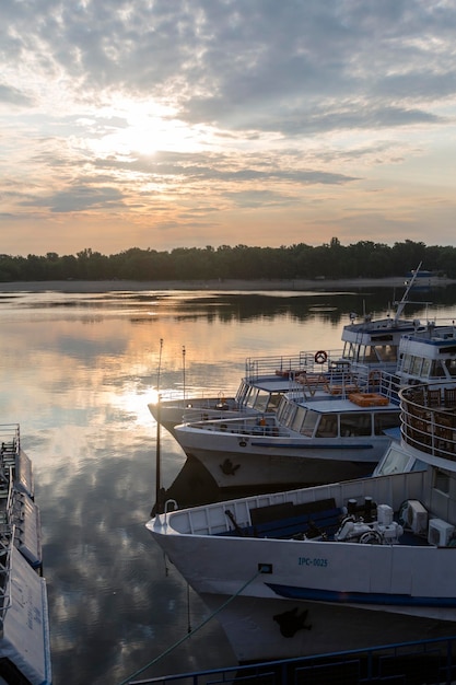 Boats in sunrise in the sunny morning on Dnipro river Kyiv Harbour city Ukraine