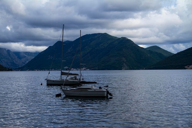 Boats on the water with mountains in the background