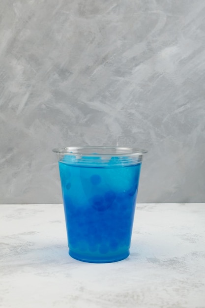 Boba drink or Blue bubble tea in plastic cup Refreshing summer cocktail with tapioca pearls