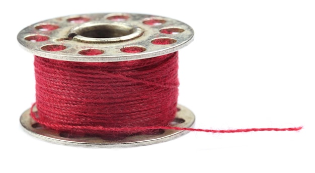 Bobbin with thread over white background