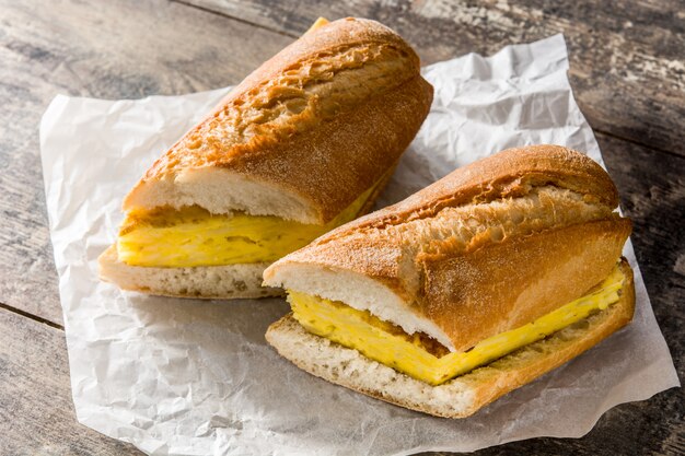 Bocadillo de tortilla española. Spanish potato omelette sandwich on wooden table