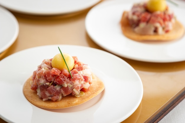 Bocado de steaktartare con esfera de Mostaza Presentado Sobre una Coca de Pan