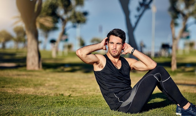 the body achieves what the mind believes shot of a young man in gymwear working out in a park
