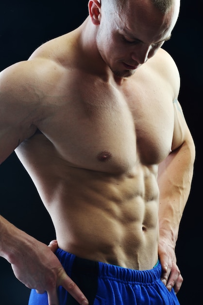 Body builder champion posing in studio