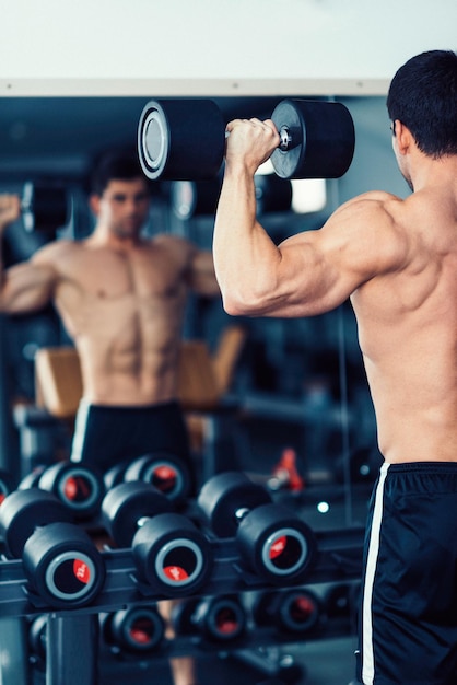 Body building champion exercising in the gym