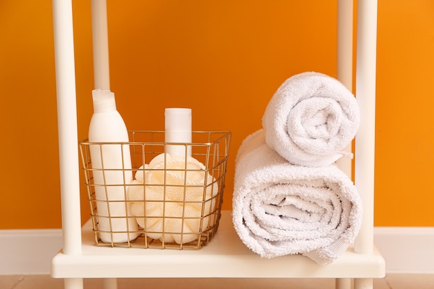 Photo body care cosmetics with accessories on shelf in bathroom